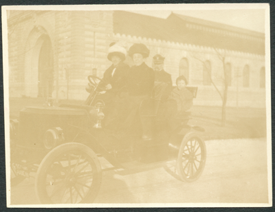 Unidentified Stanley Steam Car in front of Large Building